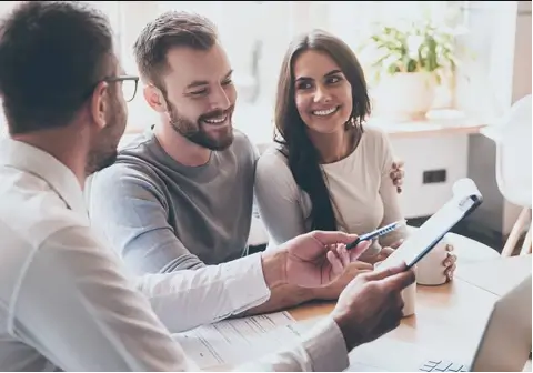 Happy couple cheering their successful new home purchase thanks to Prime Rate Mortgage ™