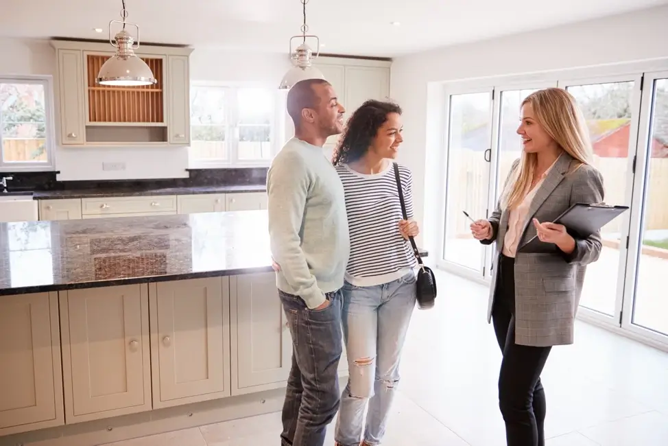 A couple talking with a realtor.