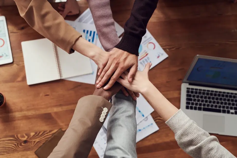 Hands from all ethnicities and beliefs together.